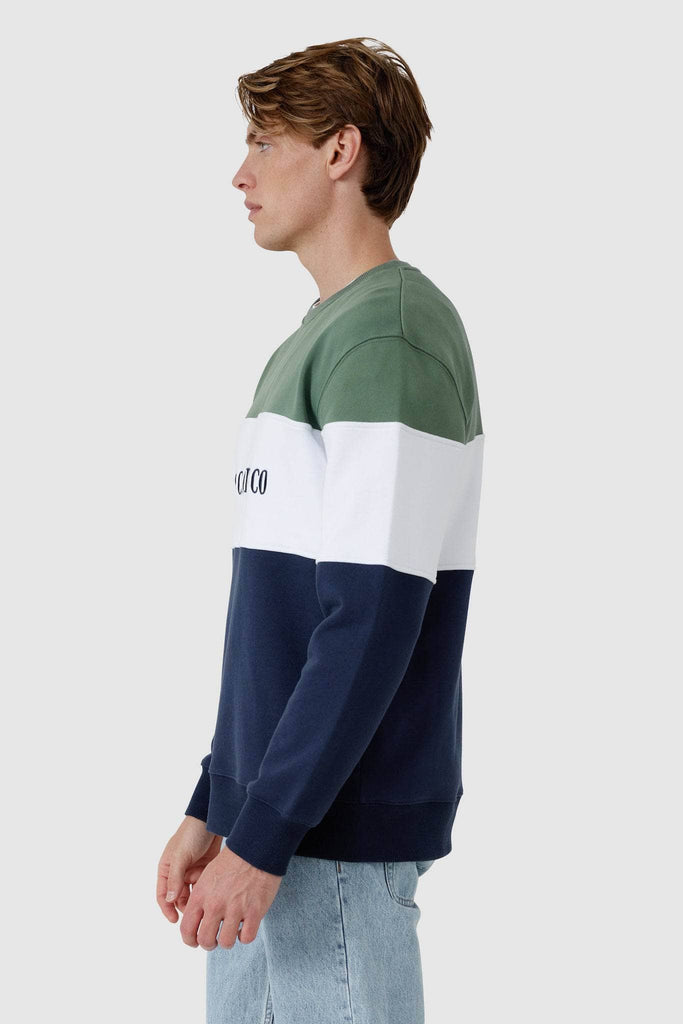 Side view of male model wearing Crew neck sweater with olive top , white middle panel with embroidered ortc clothing co and navy bottom panel