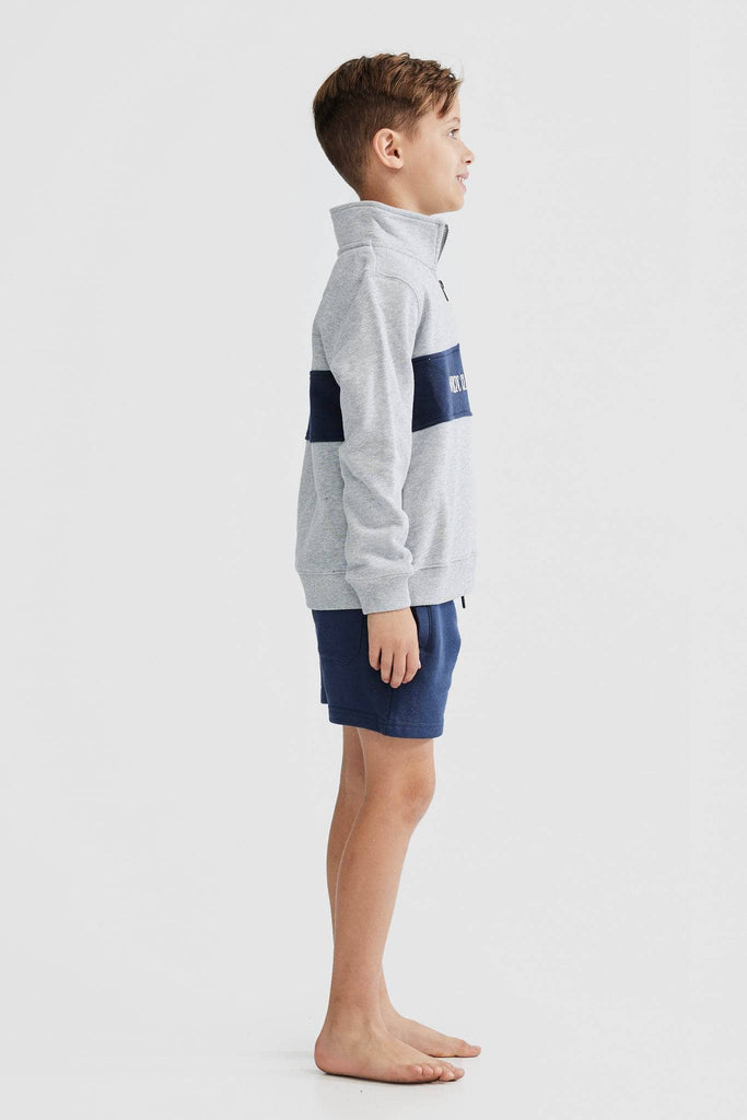 Child model wearing grey quarter zip with navy middle panel and white embroidered ortc clothing co